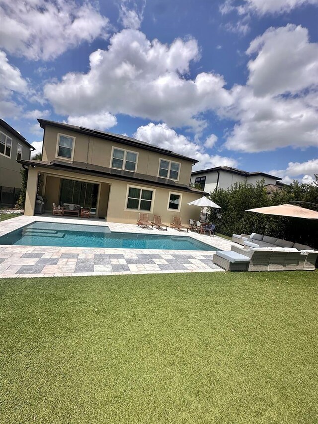 14117 Larkspur Lake Dr, Winter Garden, FL 34787 - back of house with outdoor lounge area, stucco siding, and a lawn