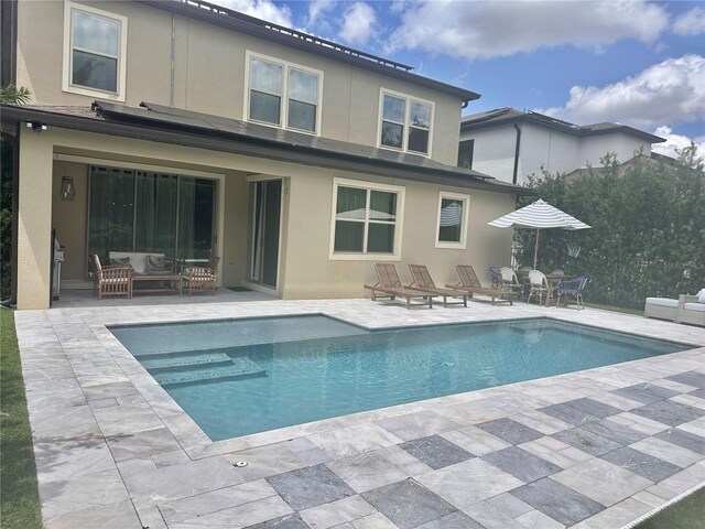 14117 Larkspur Lake Dr, Winter Garden, FL 34787 - rear view of property featuring stucco siding, a patio area, and an outdoor pool