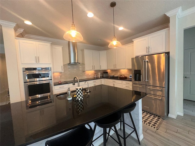 14117 Larkspur Lake Dr, Winter Garden, FL 34787 - kitchen featuring appliances with stainless steel finishes, wall chimney exhaust hood, ornamental molding, dark countertops, and a sink