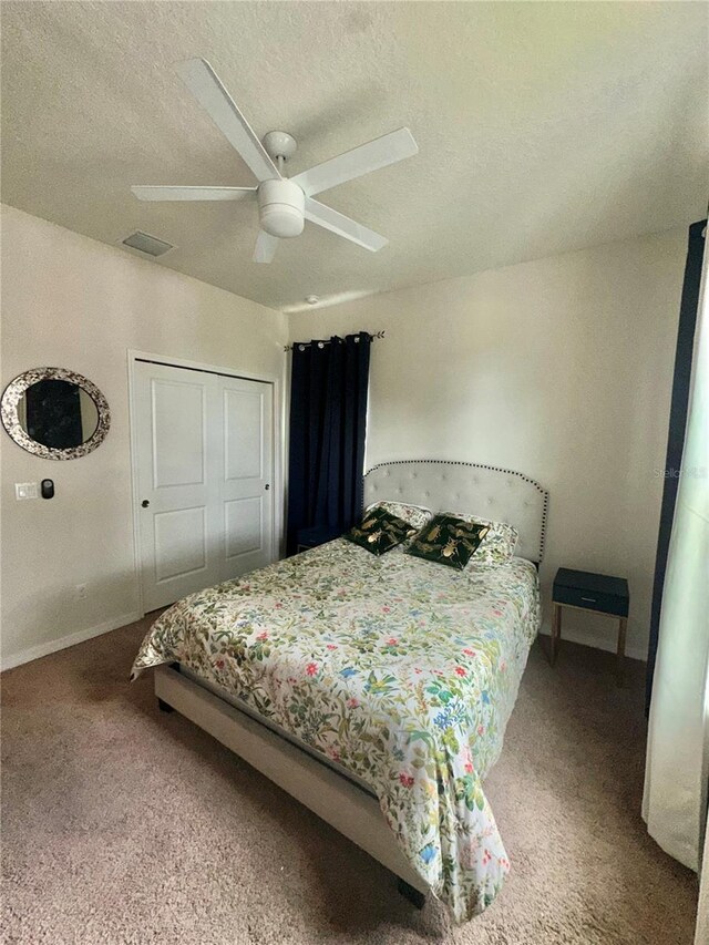 14117 Larkspur Lake Dr, Winter Garden, FL 34787 - carpeted bedroom with baseboards, ceiling fan, a textured ceiling, and a closet
