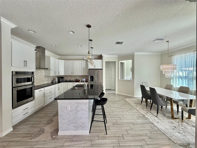 14117 Larkspur Lake Dr, Winter Garden, FL 34787 - kitchen with wall chimney exhaust hood, a sink, ornamental molding, appliances with stainless steel finishes, and tasteful backsplash