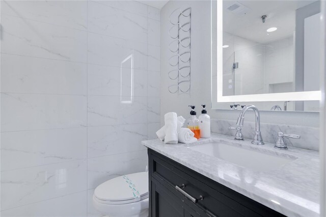 6165 Carrier Dr Unit 2605, Orlando, FL 32819 - full bathroom with vanity, toilet, tile walls, and a shower