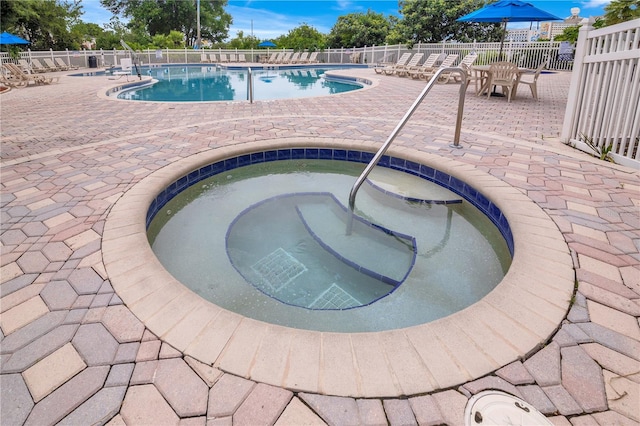 6165 Carrier Dr Unit 2605, Orlando, FL 32819 - community pool featuring a patio and a community hot tub