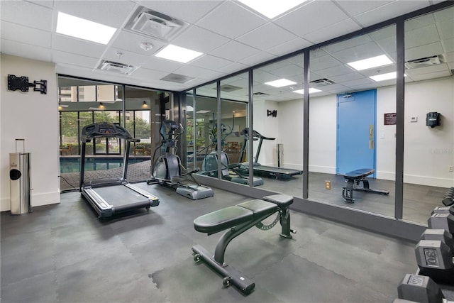 6165 Carrier Dr Unit 2605, Orlando, FL 32819 - gym featuring a drop ceiling and baseboards