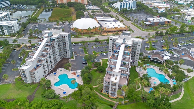 6165 Carrier Dr Unit 2605, Orlando, FL 32819 - aerial view of property and surrounding area featuring a pool and a large body of water