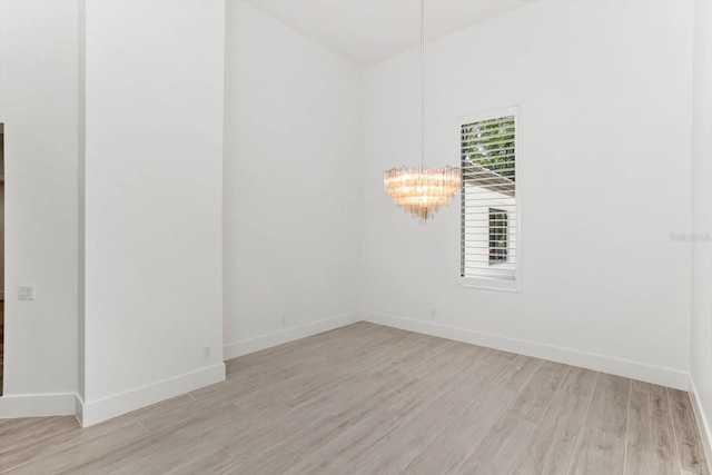 5199 Latrobe Dr, Windermere, FL 34786 - spare room with light wood-style floors, a chandelier, and baseboards