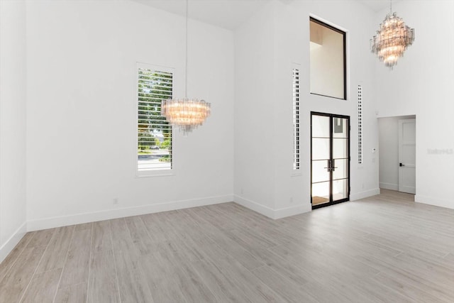 5199 Latrobe Dr, Windermere, FL 34786 - unfurnished room with a chandelier, wood finished floors, baseboards, and a towering ceiling