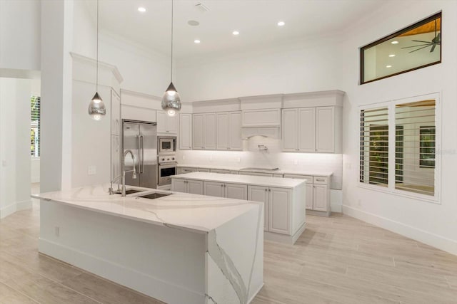 5199 Latrobe Dr, Windermere, FL 34786 - kitchen featuring built in appliances, baseboards, a kitchen island, backsplash, and crown molding