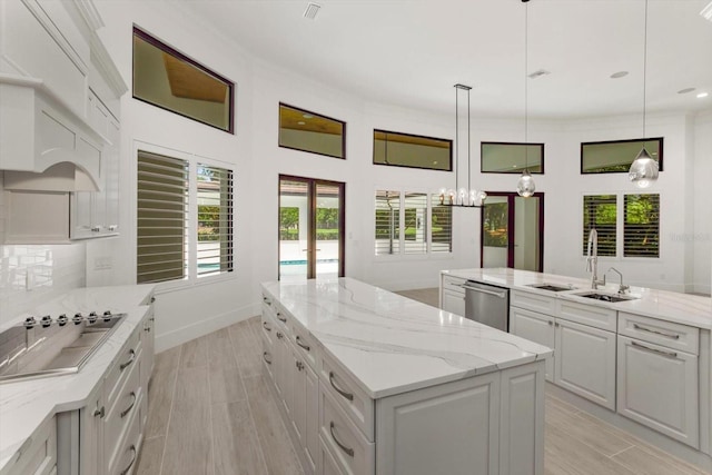 5199 Latrobe Dr, Windermere, FL 34786 - kitchen featuring black electric stovetop, a center island, dishwasher, a chandelier, and white cabinets