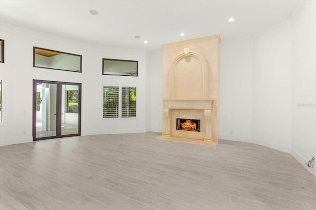 5199 Latrobe Dr, Windermere, FL 34786 - unfurnished living room featuring a premium fireplace, french doors, ornamental molding, light wood-style flooring, and recessed lighting