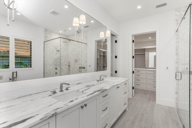 5199 Latrobe Dr, Windermere, FL 34786 - full bath featuring double vanity, a stall shower, recessed lighting, and wood finished floors
