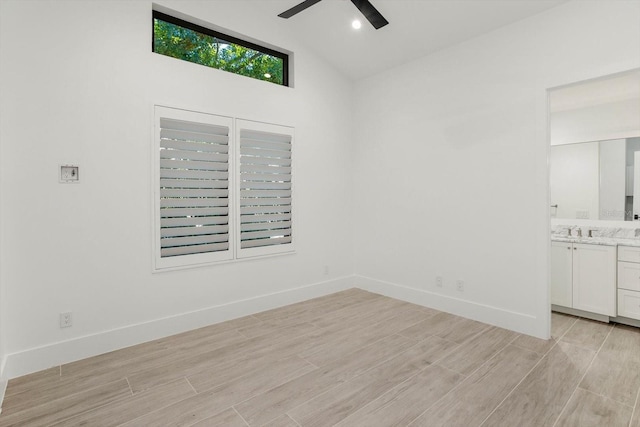 5199 Latrobe Dr, Windermere, FL 34786 - spare room with a ceiling fan, light wood-style floors, a sink, vaulted ceiling, and baseboards