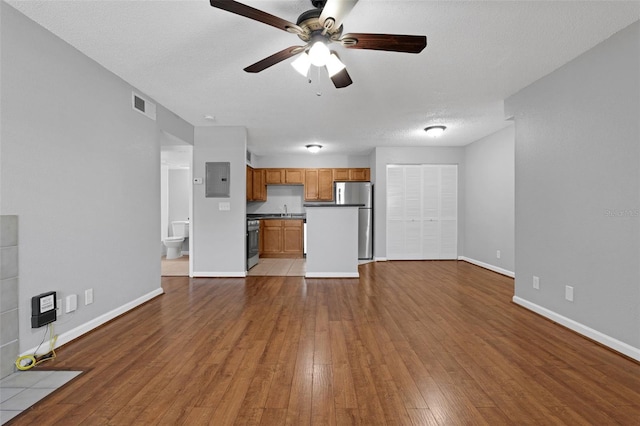 351 Lone Hill Dr Unit 206, Altamonte Springs, FL 32701 - unfurnished living room featuring a ceiling fan, hardwood / wood-style flooring, baseboards, electric panel, and a sink