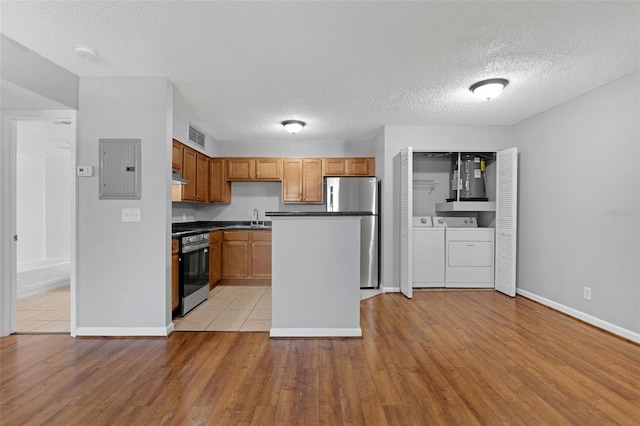 351 Lone Hill Dr Unit 206, Altamonte Springs, FL 32701 - kitchen featuring stainless steel appliances, electric panel, separate washer and dryer, dark countertops, and under cabinet range hood