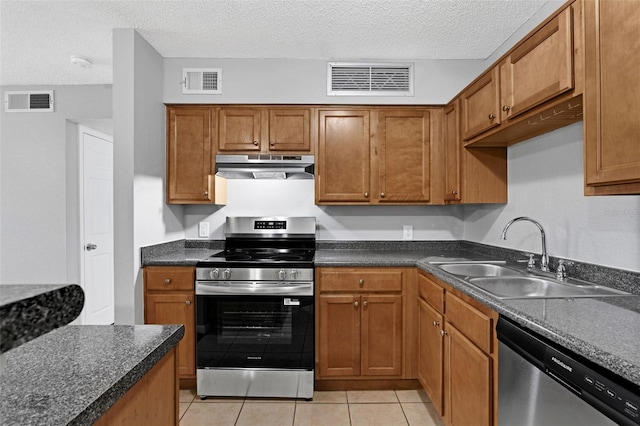 351 Lone Hill Dr Unit 206, Altamonte Springs, FL 32701 - kitchen featuring appliances with stainless steel finishes, exhaust hood, a sink, light tile patterned floors, and brown cabinetry
