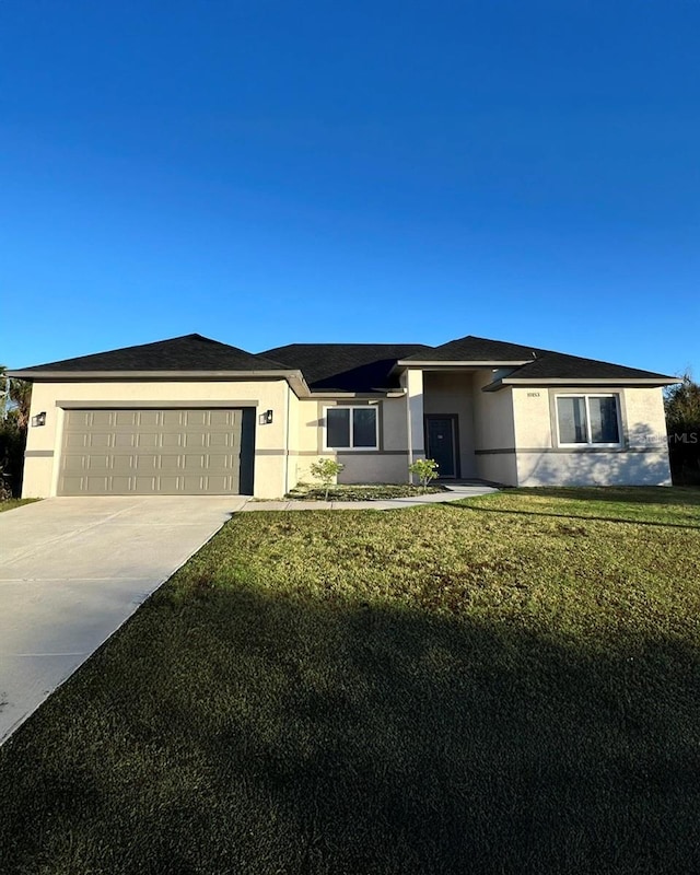 10153 Wildcat St, Port Charlotte, FL 33981 - view of front of home featuring concrete driveway, an attached garage, a front lawn, and stucco siding