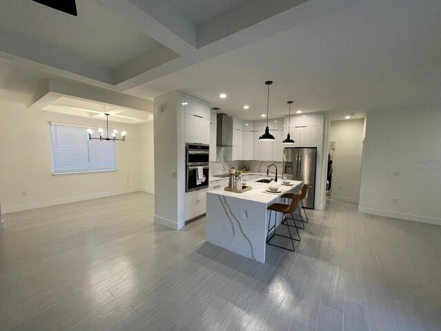 10153 Wildcat St, Port Charlotte, FL 33981 - kitchen with stainless steel appliances, a chandelier, baseboards, white cabinetry, and recessed lighting