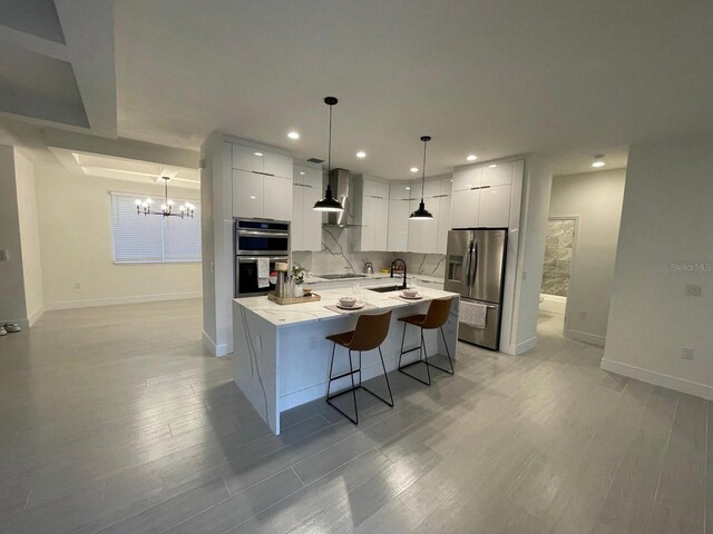 10153 Wildcat St, Port Charlotte, FL 33981 - kitchen with appliances with stainless steel finishes, modern cabinets, a chandelier, white cabinetry, and baseboards