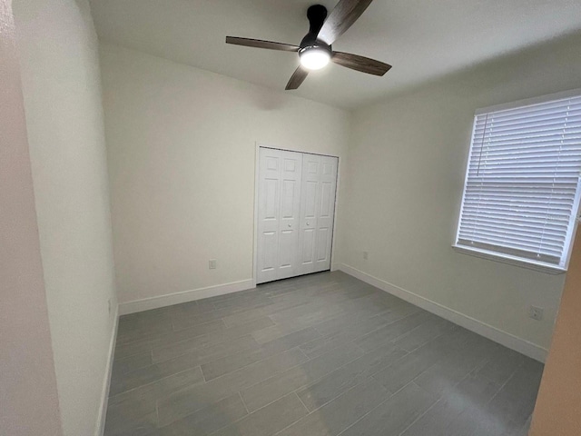 10153 Wildcat St, Port Charlotte, FL 33981 - unfurnished bedroom featuring baseboards, a closet, a ceiling fan, and dark wood finished floors