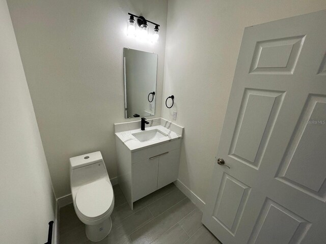 10153 Wildcat St, Port Charlotte, FL 33981 - bathroom featuring vanity, baseboards, toilet, and tile patterned floors