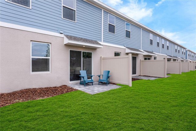 3345 Thicket St, Tavares, FL 32778 - rear view of property with a patio area, stucco siding, and roof with shingles