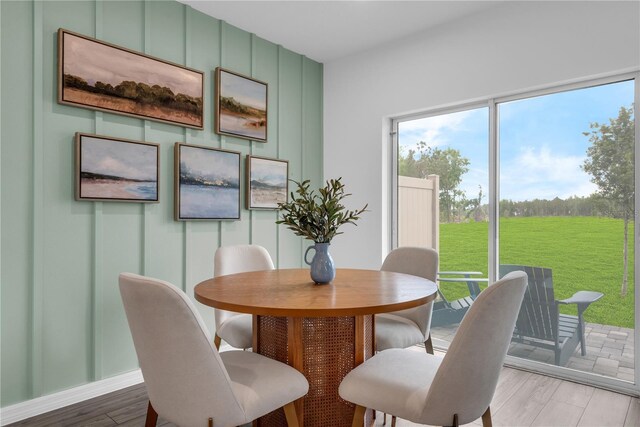 3345 Thicket St, Tavares, FL 32778 - dining area featuring light wood finished floors and a decorative wall