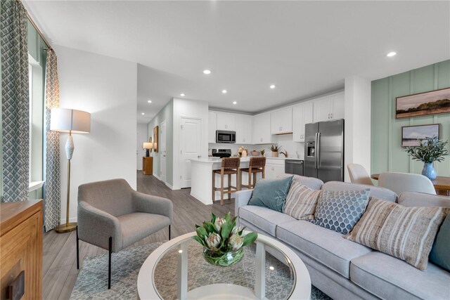 3345 Thicket St, Tavares, FL 32778 - living room with light wood-type flooring, baseboards, and recessed lighting