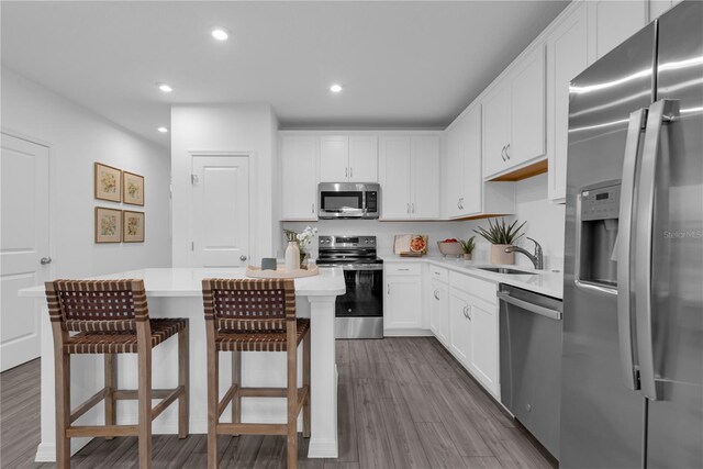 3345 Thicket St, Tavares, FL 32778 - kitchen with appliances with stainless steel finishes, a sink, light countertops, dark wood-style floors, and recessed lighting