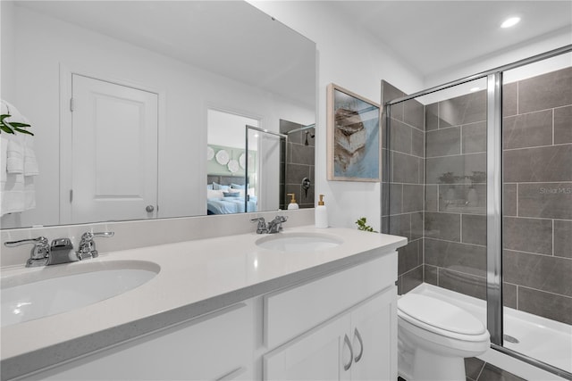 3345 Thicket St, Tavares, FL 32778 - bathroom featuring double vanity, a shower stall, ensuite bath, toilet, and recessed lighting