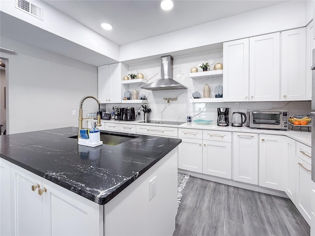 224 Hammock Dunes Pl, Orlando, FL 32828 - kitchen with open shelves, wall chimney range hood, black electric stovetop, decorative backsplash, and recessed lighting