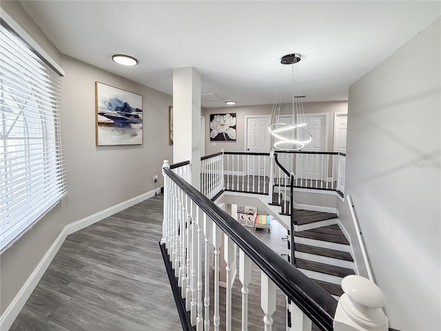 224 Hammock Dunes Pl, Orlando, FL 32828 - hall featuring an upstairs landing, baseboards, wood finished floors, and attic access