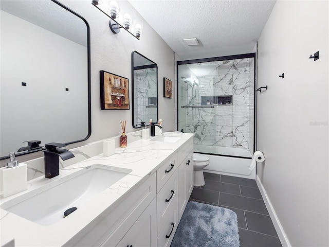 224 Hammock Dunes Pl, Orlando, FL 32828 - bathroom featuring double vanity, toilet, tile patterned floors, a textured ceiling, and shower / bath combination with glass door