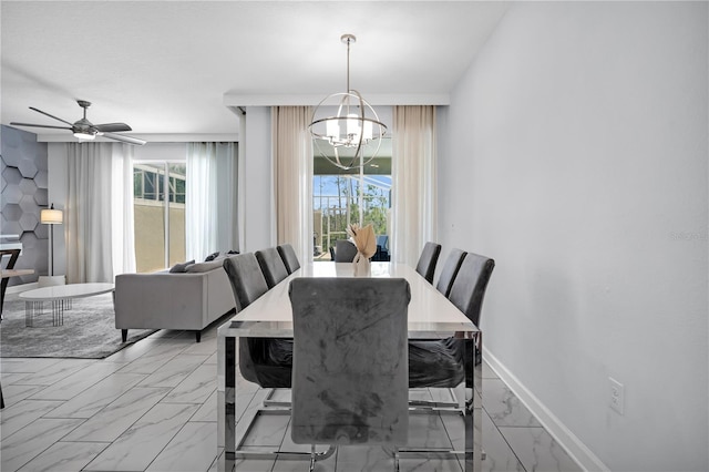 8961 Cabot Cliffs Dr, Davenport, FL 33896 - dining room featuring a chandelier, light marble finish flooring, plenty of natural light, and a ceiling fan
