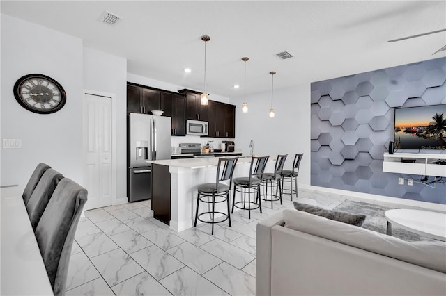 8961 Cabot Cliffs Dr, Davenport, FL 33896 - kitchen featuring stainless steel appliances, open floor plan, a breakfast bar, and recessed lighting