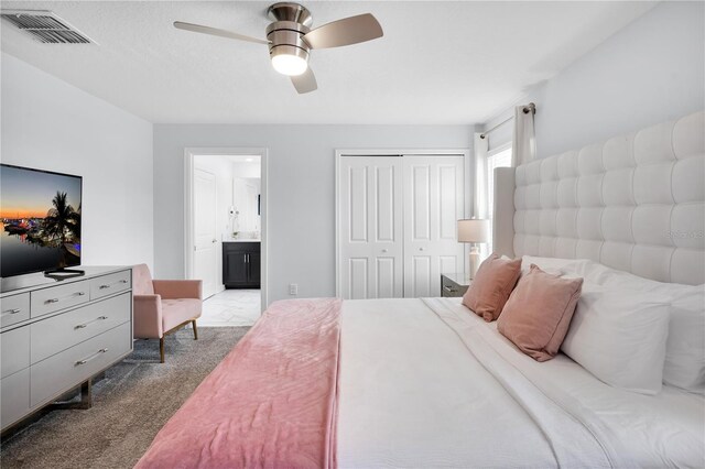 8961 Cabot Cliffs Dr, Davenport, FL 33896 - bedroom featuring carpet flooring, a closet, ensuite bathroom, and a ceiling fan