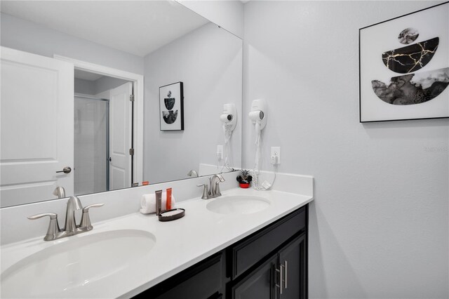 8961 Cabot Cliffs Dr, Davenport, FL 33896 - bathroom featuring double vanity and a shower with door