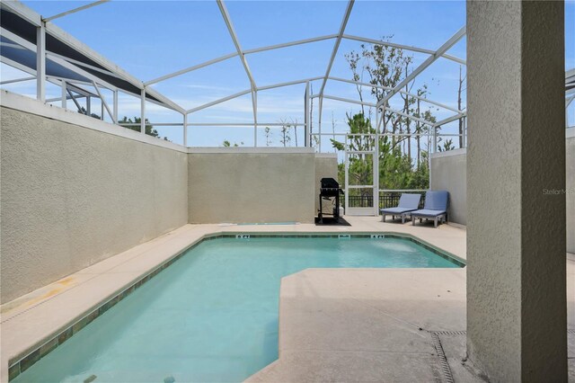 8961 Cabot Cliffs Dr, Davenport, FL 33896 - outdoor pool with a patio area, a lanai, and area for grilling