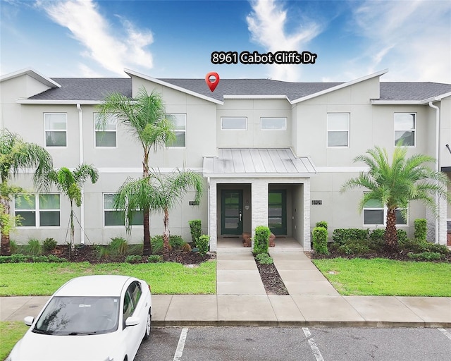 8961 Cabot Cliffs Dr, Davenport, FL 33896 - multi unit property with uncovered parking, a shingled roof, and a standing seam roof