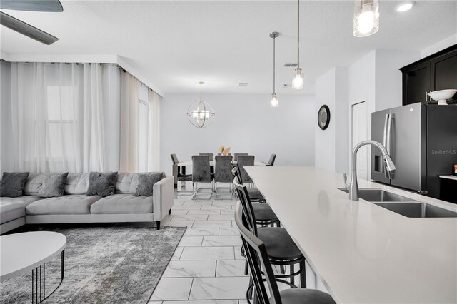 8961 Cabot Cliffs Dr, Davenport, FL 33896 - living room with light marble finish flooring and a chandelier
