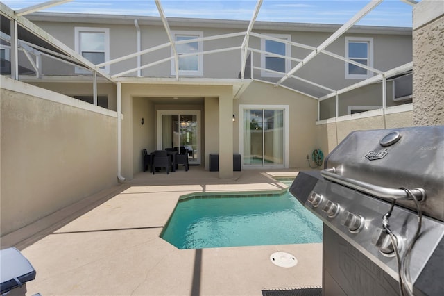 8961 Cabot Cliffs Dr, Davenport, FL 33896 - outdoor pool featuring a patio, a grill, and a lanai