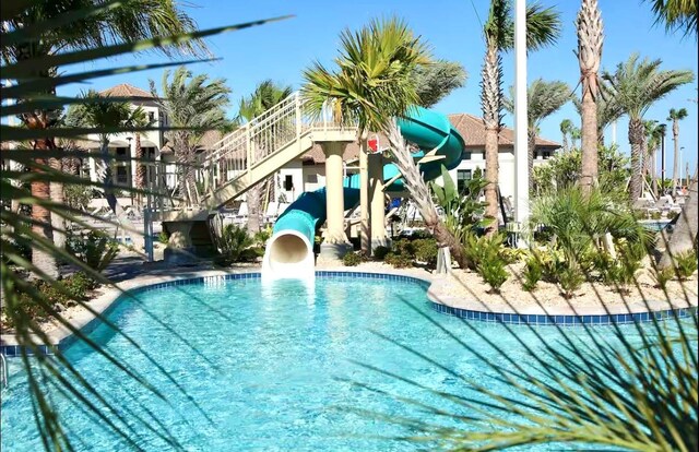 8961 Cabot Cliffs Dr, Davenport, FL 33896 - community pool with a water slide and stairs