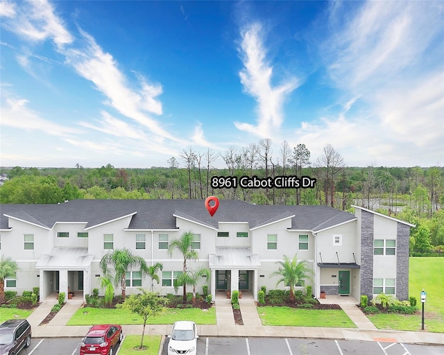 8961 Cabot Cliffs Dr, Davenport, FL 33896 - view of building exterior with uncovered parking