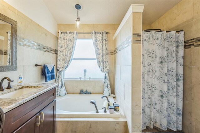 6935 Runner Oak Dr, Wesley Chapel, FL 33545 - full bathroom featuring tile walls, vanity, a bath, and tiled shower
