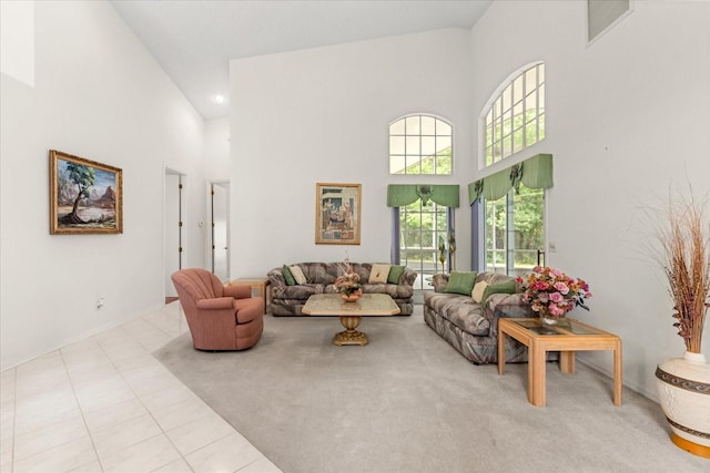 4026 S Lake Orlando Pkwy, Orlando, FL 32808 - tiled living room featuring a towering ceiling, carpet floors, and baseboards