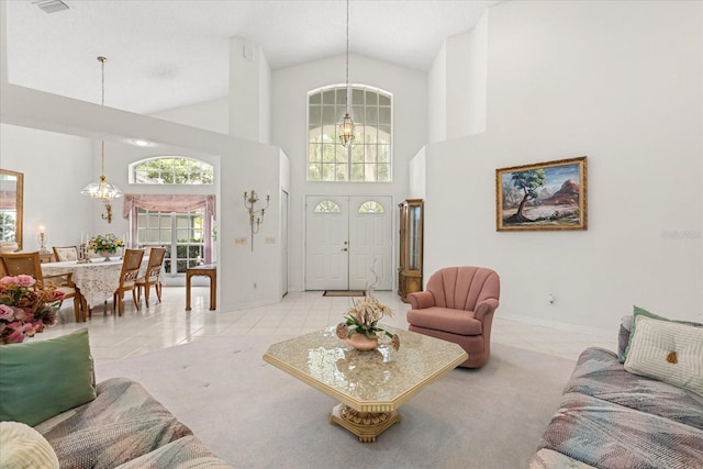 4026 S Lake Orlando Pkwy, Orlando, FL 32808 - living area featuring high vaulted ceiling, baseboards, and a chandelier