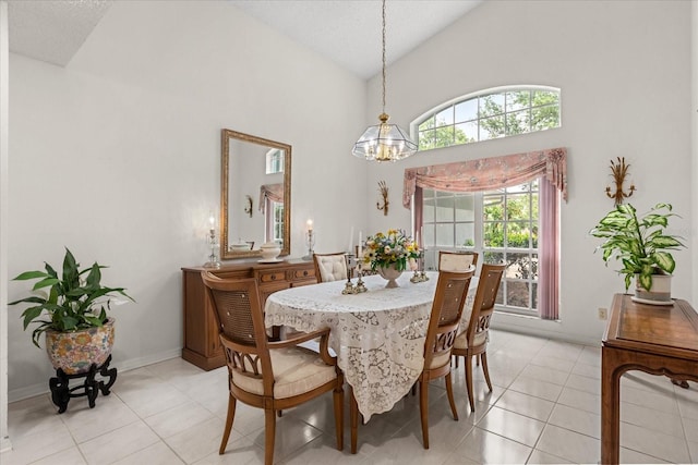 4026 S Lake Orlando Pkwy, Orlando, FL 32808 - dining room with a chandelier, light tile patterned floors, high vaulted ceiling, and baseboards