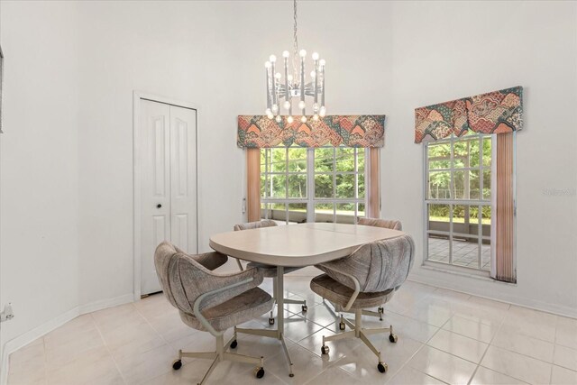 4026 S Lake Orlando Pkwy, Orlando, FL 32808 - dining area featuring a towering ceiling, a chandelier, baseboards, and light tile patterned floors