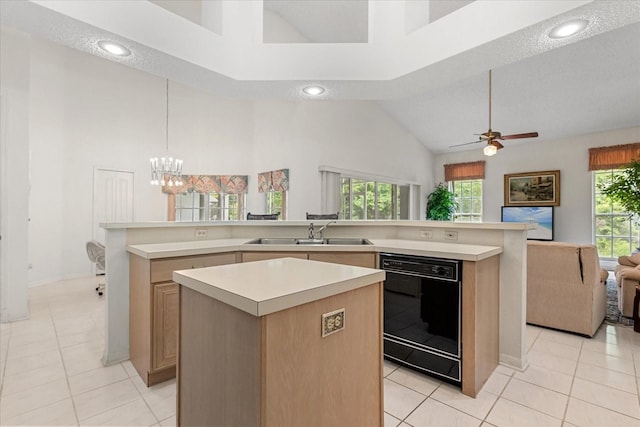 4026 S Lake Orlando Pkwy, Orlando, FL 32808 - kitchen with black dishwasher, a sink, a kitchen island, open floor plan, and high vaulted ceiling