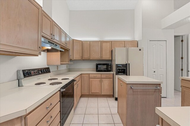 4026 S Lake Orlando Pkwy, Orlando, FL 32808 - kitchen featuring range with electric cooktop, under cabinet range hood, black microwave, white fridge with ice dispenser, and light tile patterned flooring