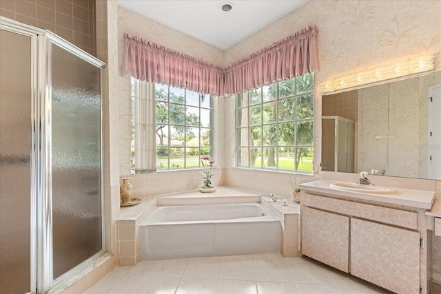 4026 S Lake Orlando Pkwy, Orlando, FL 32808 - bathroom featuring a shower stall, a garden tub, vanity, and wallpapered walls